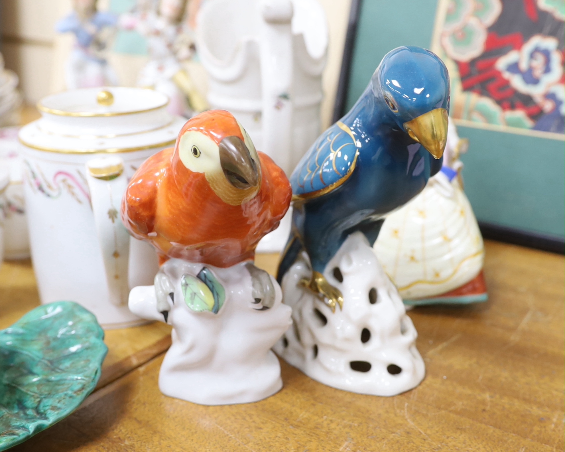 Assorted Continental ceramics, mainly 19th century, including two figures of parrots, two candle holders in the form of musicians, a teapot, jugs, various cups and sauces, etc.